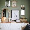 Stylish green living room with gallery wall and white sideboard