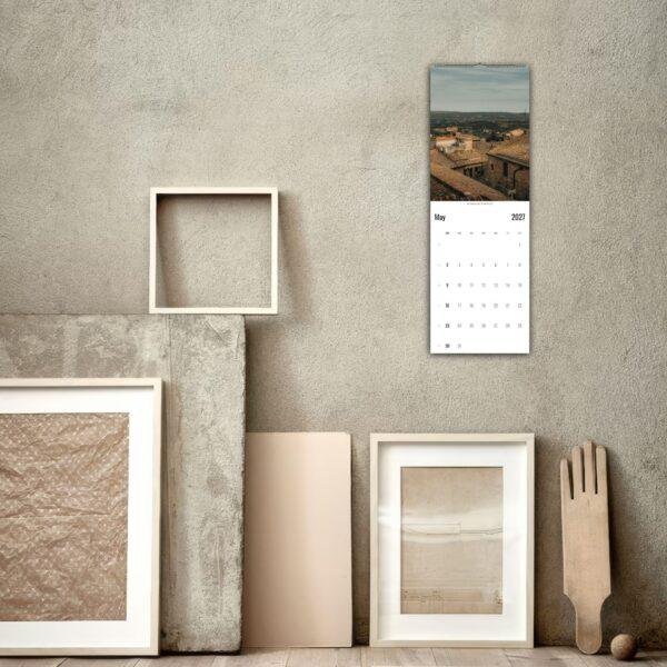 2027 wall calendar with rooftop photo in rustic room