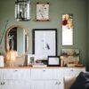 Stylish green living room with gallery wall and white sideboard