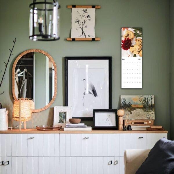 Stylish green living room with gallery wall and white sideboard