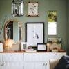 Stylish green living room with gallery wall and white credenza