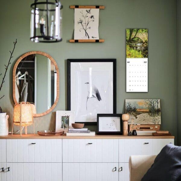 Stylish green living room with gallery wall and white credenza