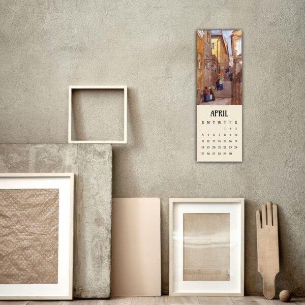 April wall calendar with street scene painting above frames