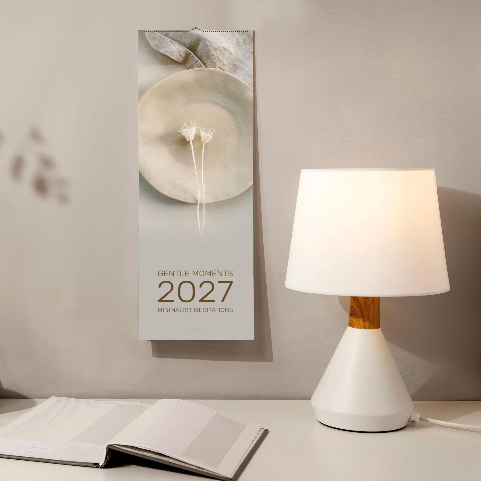 2027 minimalist wall calendar beside a glowing table lamp