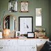 Stylish green living room with gallery wall and sideboard