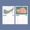 2027 wall calendar showing November peacock and December cat illustrations