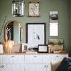 Stylish green living room sideboard with eclectic wall decor