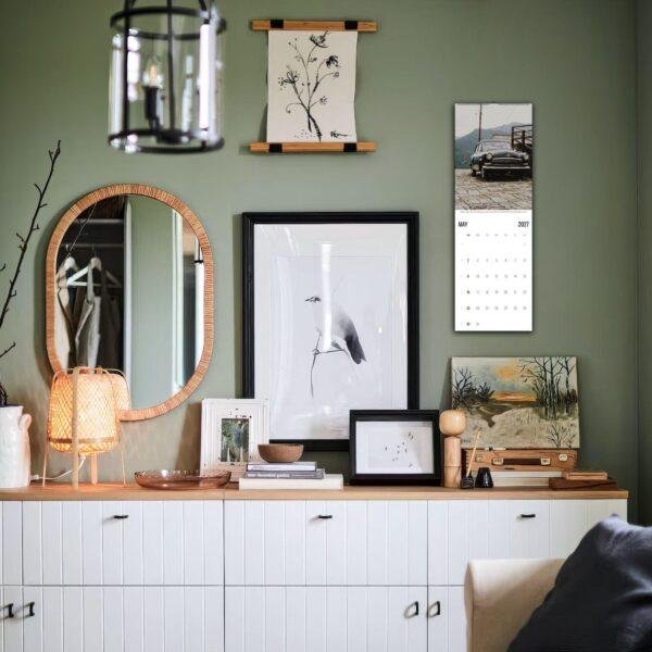 Stylish green living room sideboard with eclectic wall decor