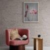 Cozy reading nook with pink armchair and floral wall art