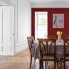 Elegant dining room with red accent wall and wooden furniture
