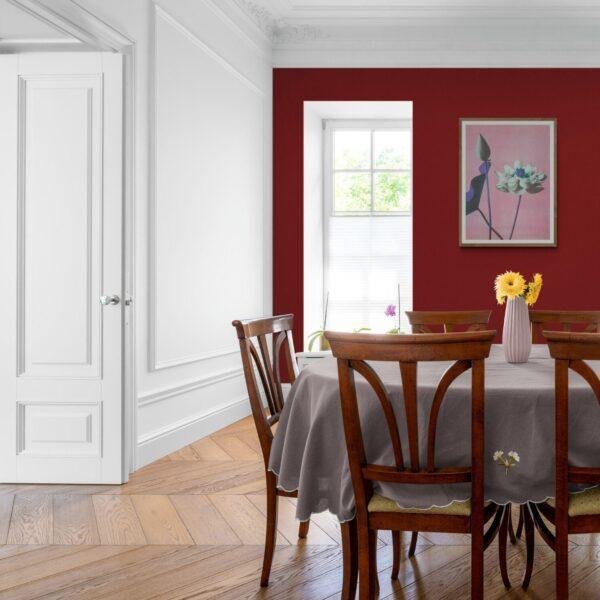 Elegant dining room with red accent wall and wooden furniture