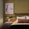 Cozy bedroom with floral art print above nightstand