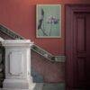 Lotus flower art print on red wall near marble staircase