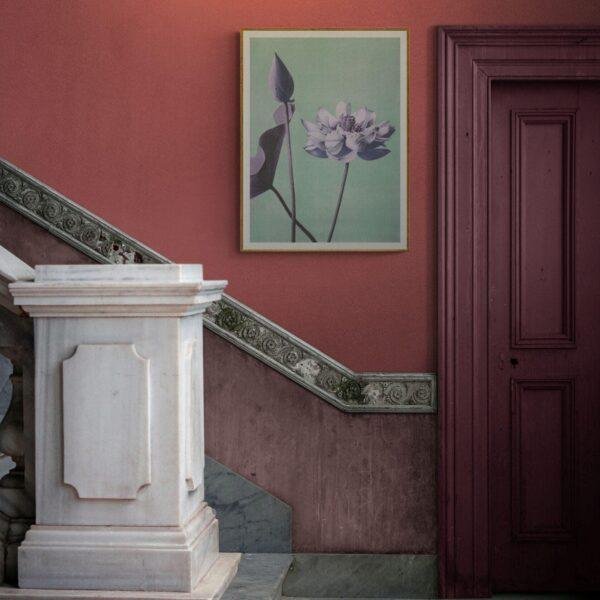 Lotus flower art print on red wall near marble staircase
