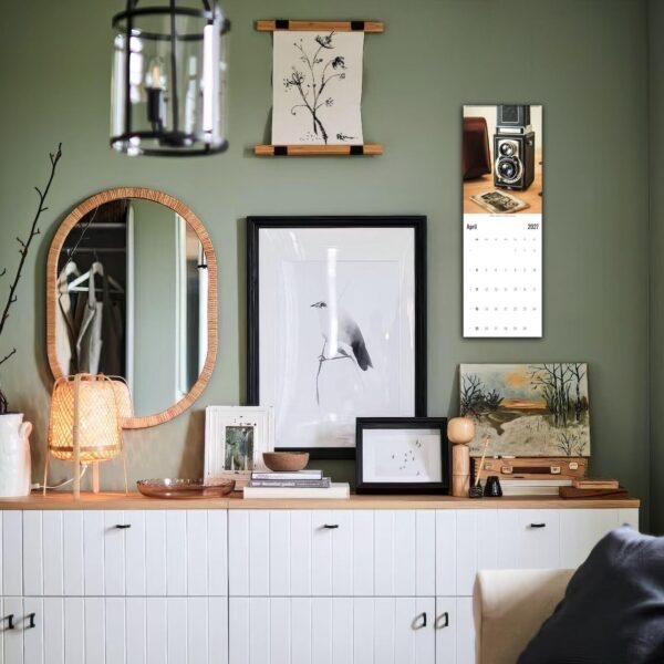 Stylish green living room with gallery wall and credenza