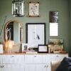 Stylish green-walled room with gallery wall and white credenza