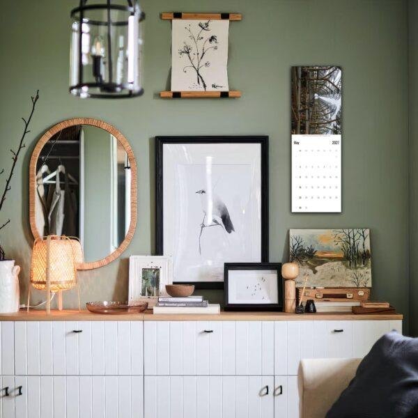 Stylish green-walled room with gallery wall and white credenza