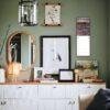 Stylish green living room with gallery wall and white credenza