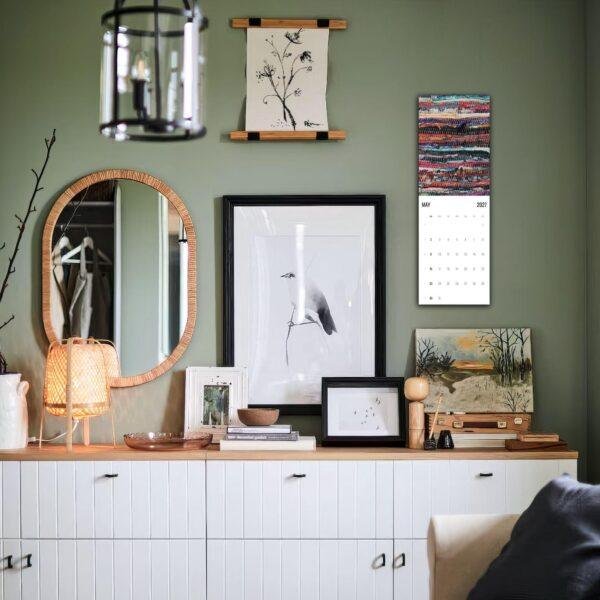 Stylish green living room with gallery wall and white credenza