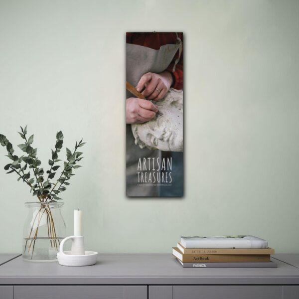 Artisan Treasures 2027 calendar hanging on wall above shelf