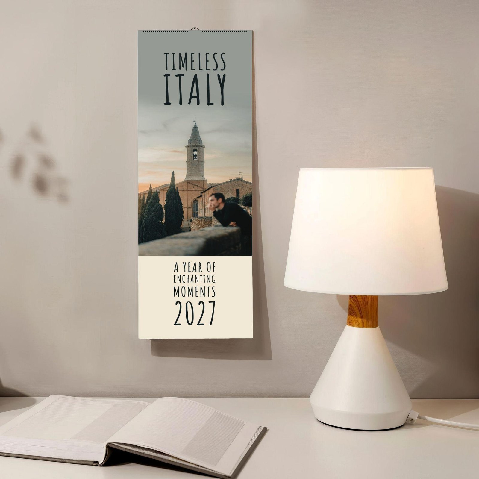 Timeless Italy 2027 wall calendar hanging beside a lamp