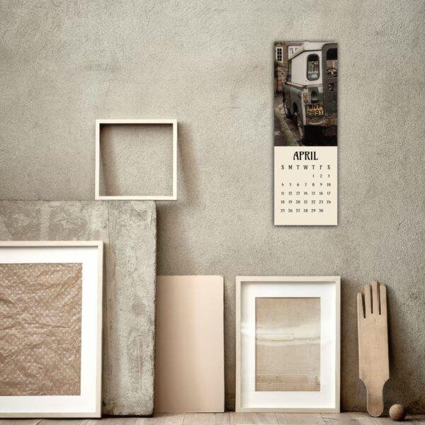 April wall calendar with vintage Land Rover photo in rustic room