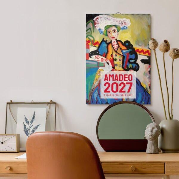 Amadeo 2027 art calendar hanging above a stylish desk