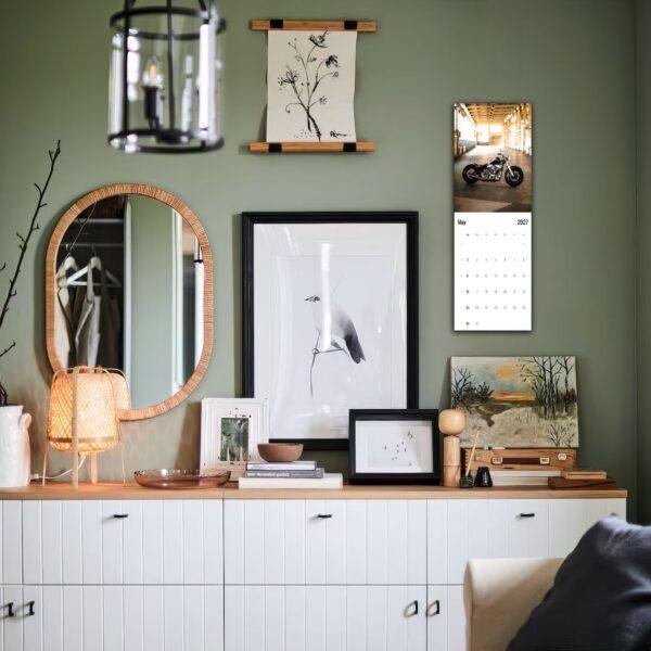 Stylish green living room with gallery wall and white sideboard