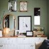 Stylish green living room with gallery wall and white sideboard