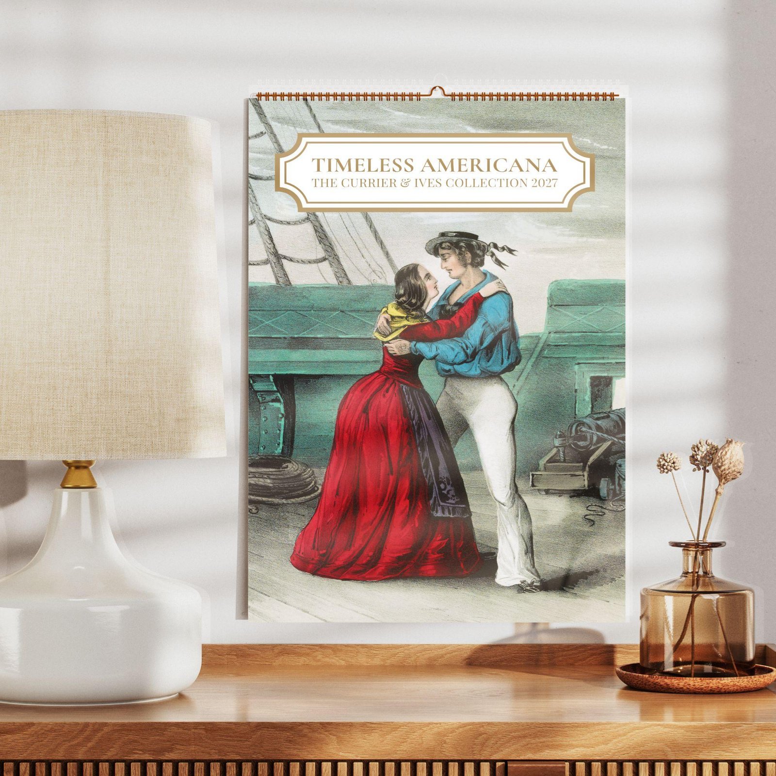 Currier and Ives 2027 wall calendar on wooden shelf