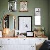 Stylish green living room with gallery wall and white dresser
