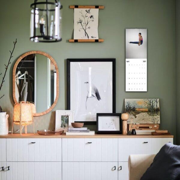 Stylish green living room with gallery wall and white dresser