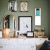 Stylish green living room with gallery wall and white sideboard