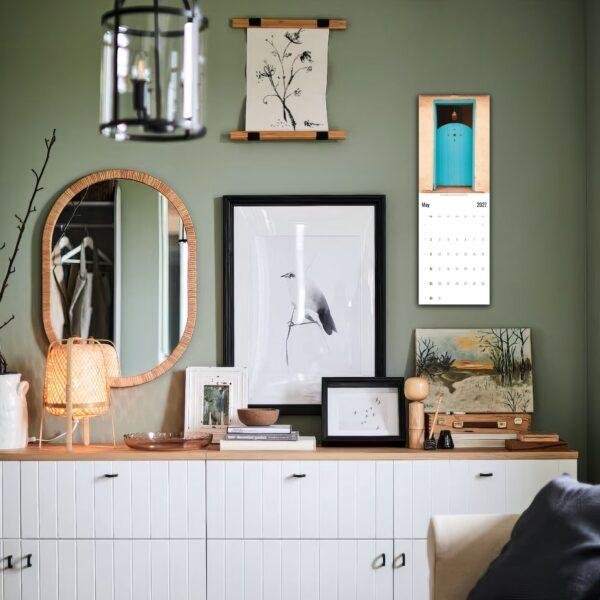 Stylish green living room with gallery wall and white sideboard