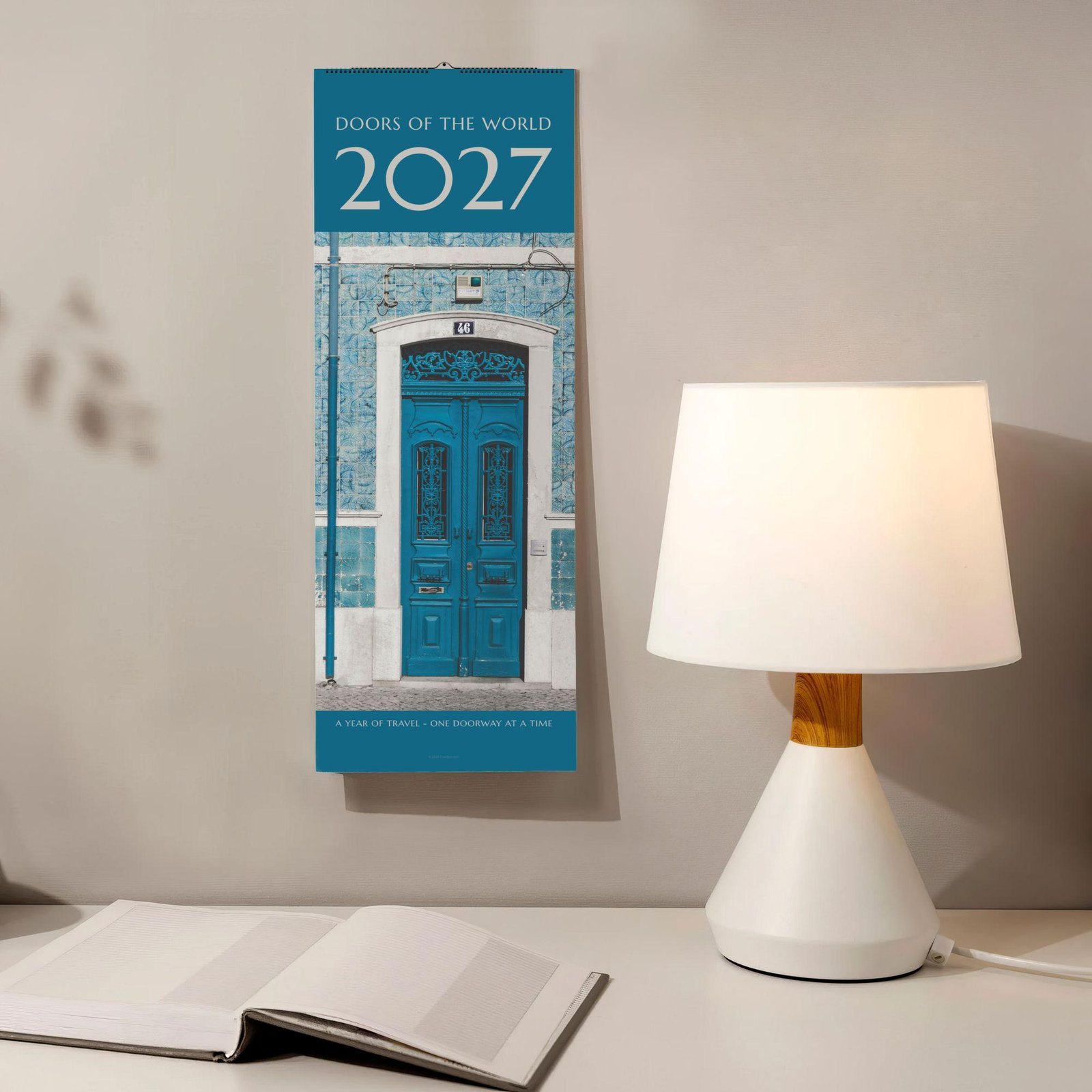 2027 Doors of the World wall calendar hanging above desk