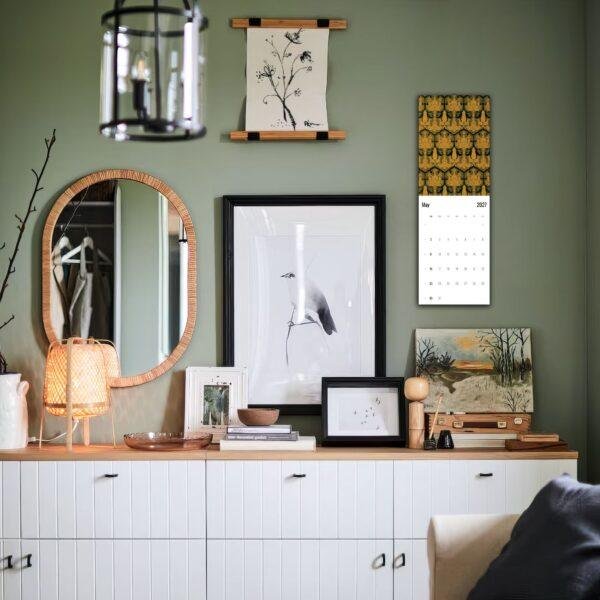 Stylish green living room with gallery wall and sideboard