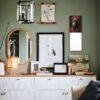 Stylish green bedroom dresser with eclectic gallery wall decor