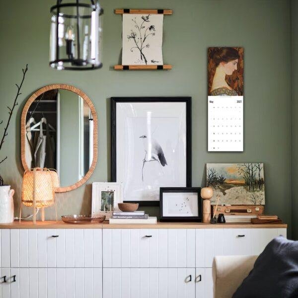 Stylish green bedroom dresser with gallery wall decor
