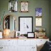 Stylish green wall gallery with white sideboard and decor