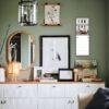 Stylish green living room with gallery wall and sideboard