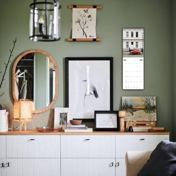 Stylish green living room with gallery wall and sideboard