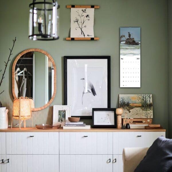 Stylish green room with gallery wall and white sideboard