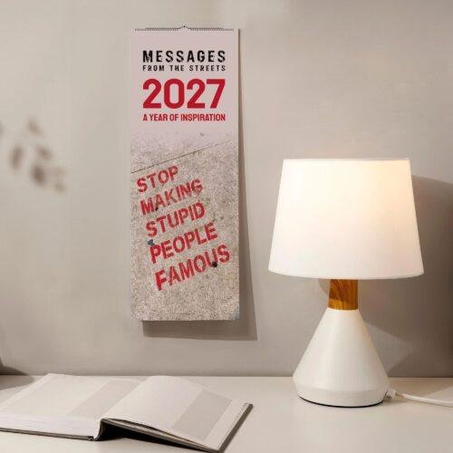 2027 inspirational street art wall calendar hanging beside lamp