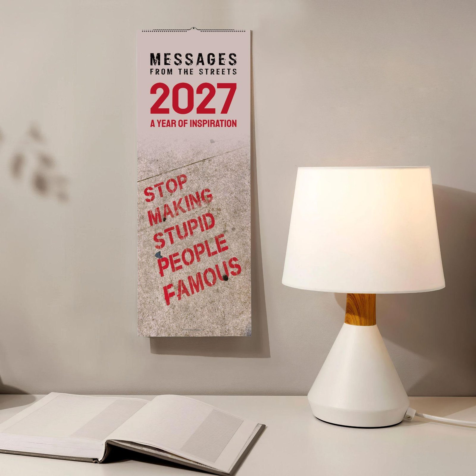2027 inspirational street art wall calendar hanging beside lamp