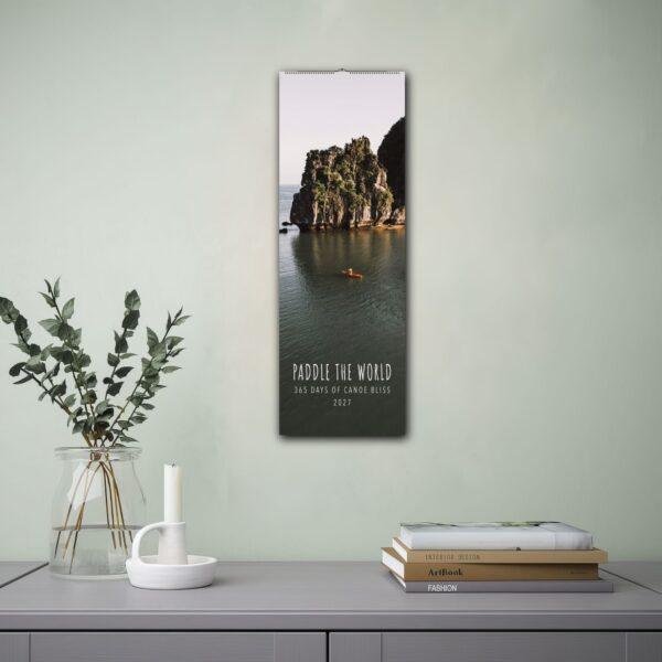 2027 Paddle the World canoe wall calendar hanging on wall