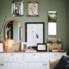 Stylish green bedroom wall with gallery art and white dresser