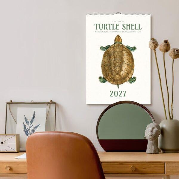 2027 Turtle Shell wall calendar hanging above stylish desk