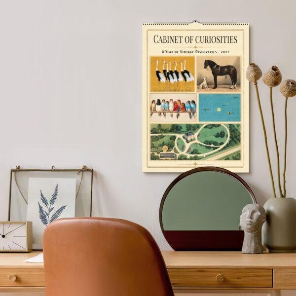 Cabinet of Curiosities 2027 vintage wall calendar above desk
