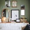 Stylish green living room with gallery wall and sideboard