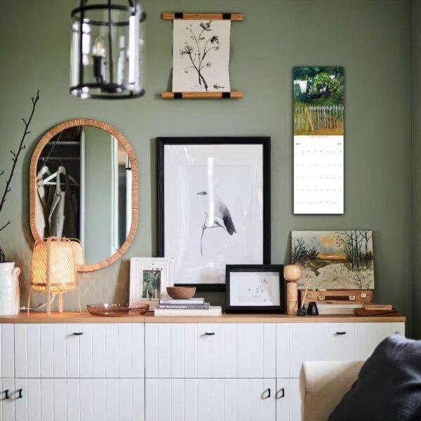 Stylish green wall gallery with mirror and artwork display